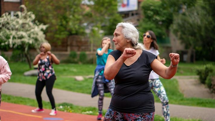 Gentle tai chi chair exercises for seniors practice in a safe, uncluttered setting